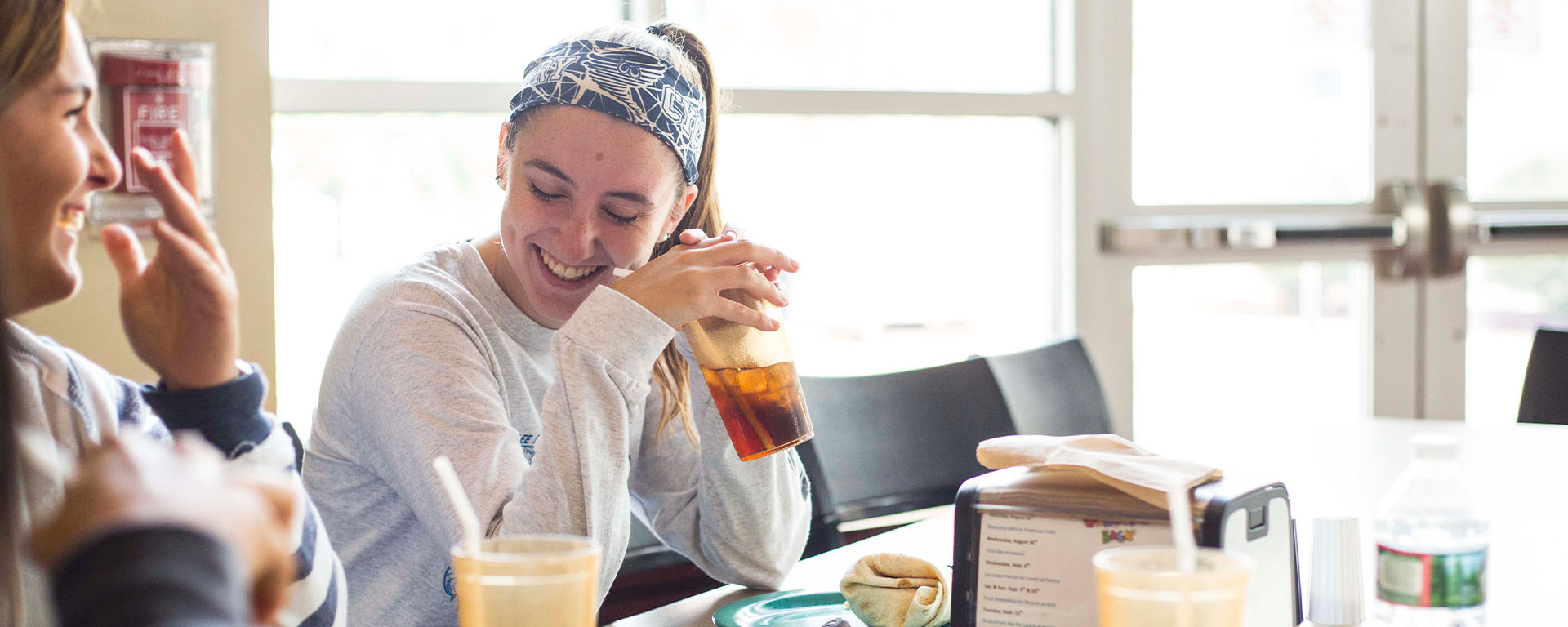 campusdining girl drinking drink at table