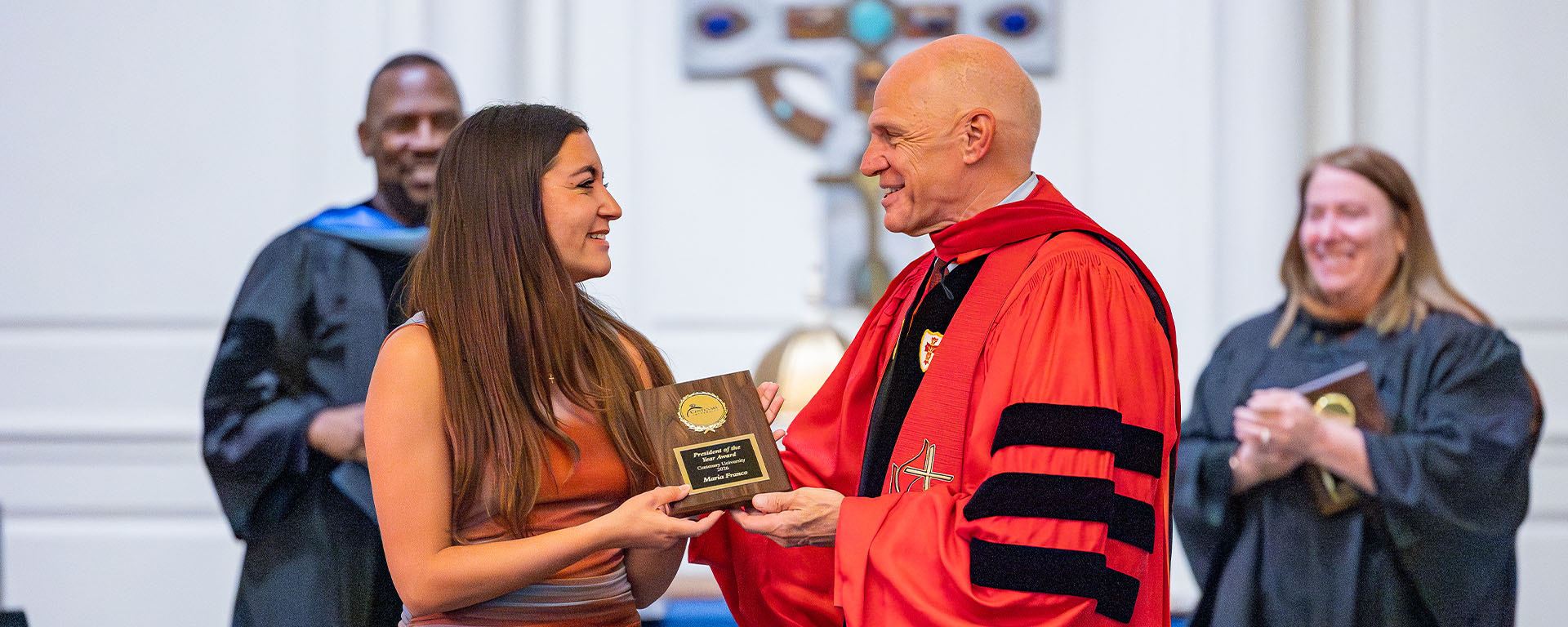 female student receiving award from president